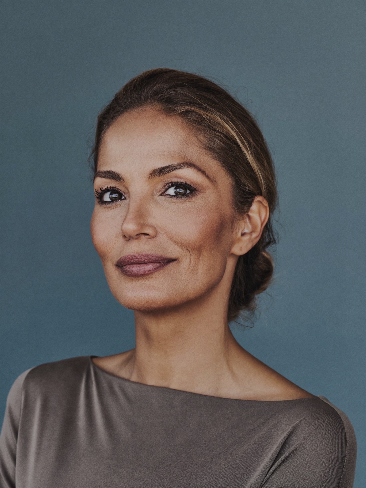 A confident woman in her early fifties, looking relaxed and refreshed